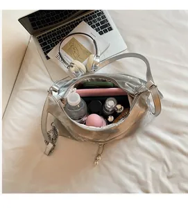 Top view showing the spacious interior of a silver tote bag with daily essentials inside