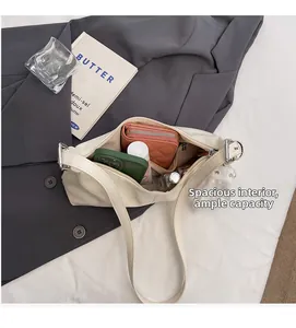 Detail view showing spacious interior with zipper pocket and beige lychee texture leather