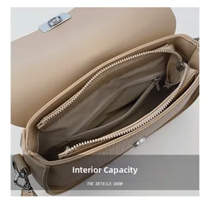 Detail view of khaki shoulder bag interior featuring main compartment and zipper pocket