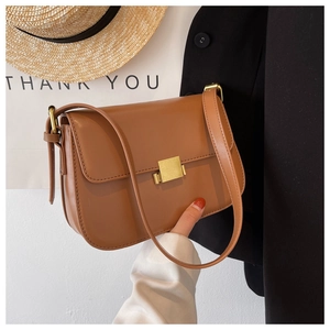 Close-up of brown faux leather crossbody bag featuring a golden square metal lock and strap
