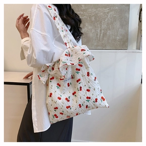 Mesh shoulder bag with cherry print and ruffles shown on model for a trendy rural style