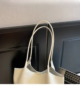Close-up of white crocodile pattern tote bag with comfortable double shoulder straps