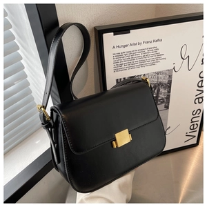 Detail view of the black leather shoulder bag with minimalist golden square metal buckle