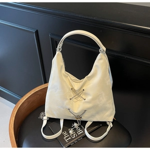 Detail of white nylon tote with cloud pattern, pearl butterfly charm and chain straps