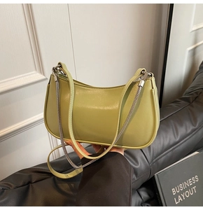 Detail of avocado green leather shoulder bag with silver metal chain and zipper