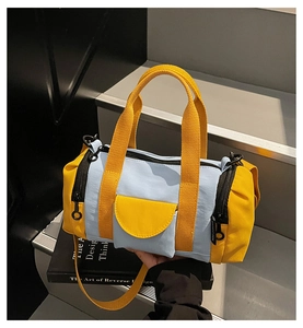 Detail of blue and yellow canvas Boston bag with side pocket and shoulder strap