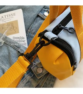 Detail of durable strap hook and two-tone yellow and blue Boston bag craftsmanship