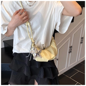 Détail du sac demi-lune jaune clair avec bandoulière corde et breloque étoile de mer