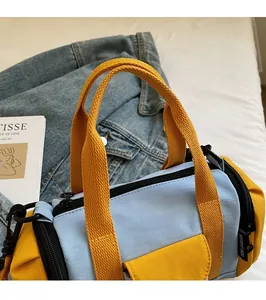 Detail of the blue and yellow nylon Boston bag with double zippers and webbed handles