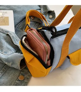 Close-up of the side pocket on a bicolor Boston bag showing functional storage space