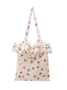 Minimalist cream canvas tote bag with red cherry prints and decorative ruffle trim edges