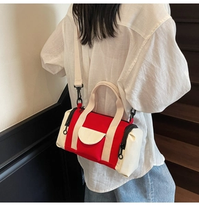 Detail of red and white Boston bag with canvas texture and detachable shoulder strap