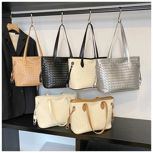 Detailed close-up showing textured woven patterns of large commuter tote bags in five colors