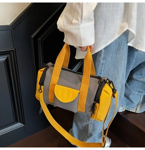 Detail of Boston bag showing grey and yellow contrast colors and multi-pocket design