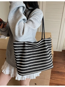 Large woven tote bag with classic black and white horizontal stripes and leather straps