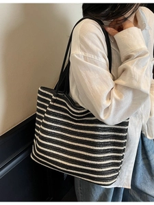 Classic woven tote bag with black and white horizontal stripes and long shoulder straps