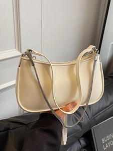 Chic cream white baguette shoulder bag with leather strap and decorative silver chain