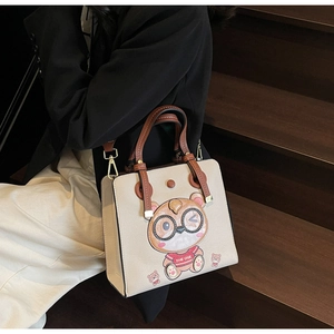 Detail of beige tote bag with cute cartoon bear patch embroidery on high-quality faux leather