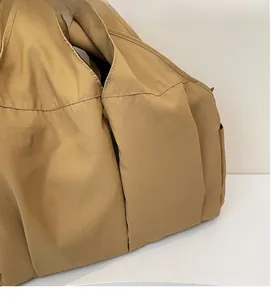 Detail shot of khaki tote bag showing soft textured fabric and elegant fold texture