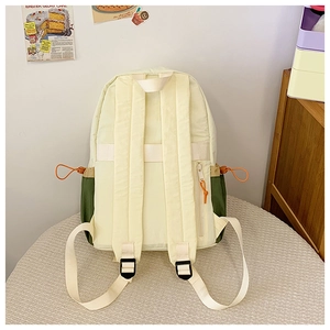Detail view of nylon backpack with olive side pocket and orange elastic drawstring