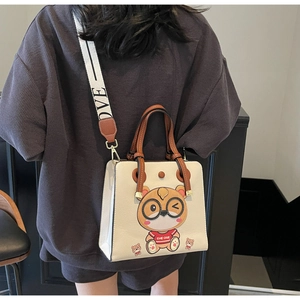 Detail of white leather tote bag with cartoon tiger print and LOVE strap