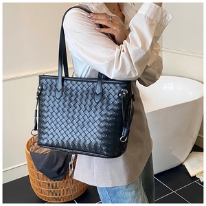 Detail of the black woven leather texture on a large capacity stylish tote bag