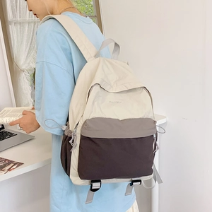Detail view of the water-resistant nylon fabric and multi-pocket layout on the backpack