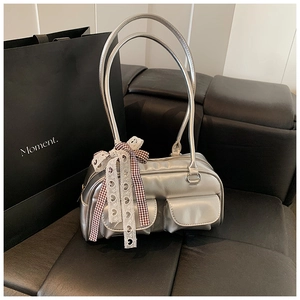 Detail of silver metallic pillow bag featuring vintage plaid bows and lace heart ribbons