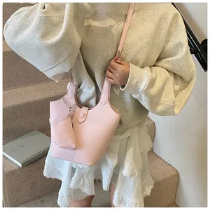 Detail view of pink lychee pattern bucket bag with matching clip-on coin purse