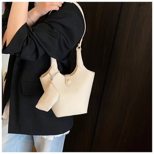 Chic cream white bucket bag with pebble leather texture and mini zip pouch detail
