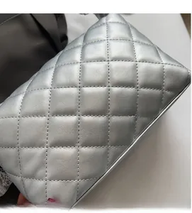 Close-up of silver quilted leather texture with premium pearlescent finish and stitching
