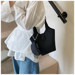 Chic black litchi pattern bucket bag with silver chain and mini pouch on model