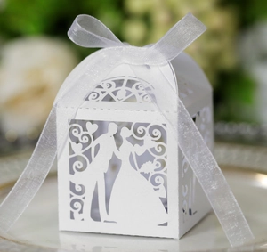 Laser-cut white wedding candy box with bride and groom silhouette and organza ribbon