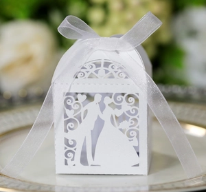 Detailed laser cut wedding candy box with bride and groom silhouette and white ribbon bow