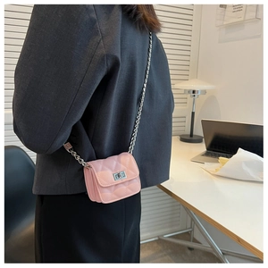 Detail of pink quilted mini crossbody bag for girls with silver chain and metal clasp