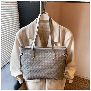 Close-up of metallic silver woven tote bag with slim handles for women's daily commute