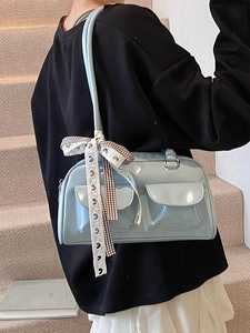 Light blue patent leather shoulder bag with a plaid bow tie and twin front flap pockets