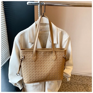 Macro detail of khaki woven leather tote bag with elegant metallic ring buckle