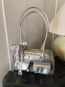 Silver metallic leather shoulder bag with bow charm and dual pockets in Y2K aesthetic