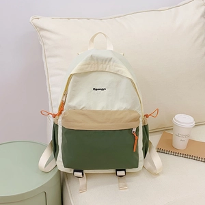 Detailed side view of nylon color-block backpack with drawstring pocket and brand logo