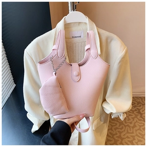 Detail of light pink pebble grain bucket bag with matching mini coin purse attachment