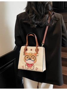 Beige tote bag with cartoon bear print and wide strap for casual summer styling