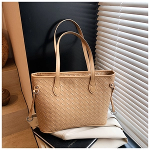 Detail of woven leather tote bag with a removable printed wide shoulder strap