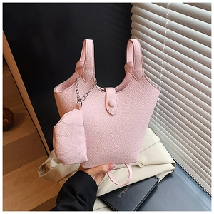 Pink lychee grain leather bucket bag with matching mini pouch and metal chain detail