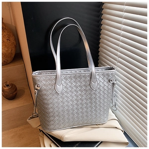 Detailed macro view of the silver woven texture on a stylish large tote handbag