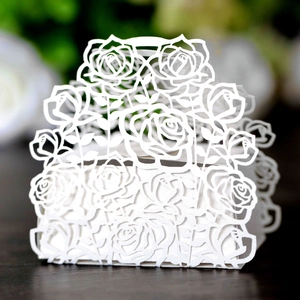Detailed laser-cut rose pattern on white wedding favor box for candies and chocolates