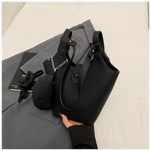 Detailed view of black lychee texture bucket bag set with silver chain and coin purse