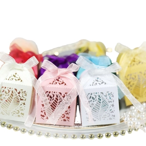 Laser-cut leaf pattern candy boxes in assorted colors with silk ribbons for weddings