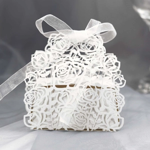 Detailed view of white laser-cut rose hollow gift box with elegant ribbon bow