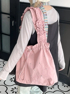 Pink nylon tote bag with ruffled strap and silver rivet accents for women